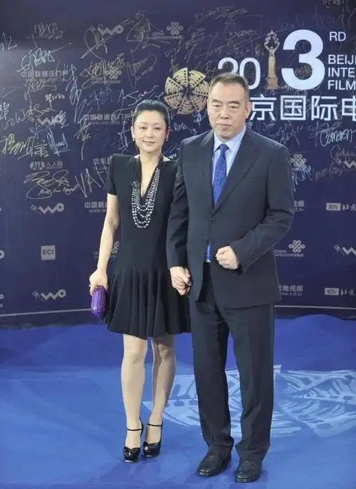 陈红和陈凯歌一起亮相,穿蛇纹图案外套内搭橙色连衣裙,端庄大气