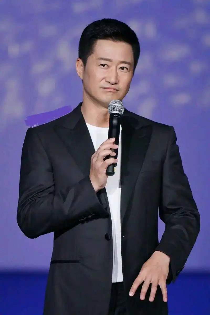 吴京脚踩白色皮鞋,还留着帅气