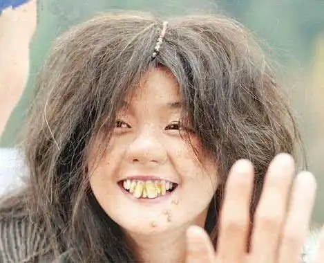 涂黑,还化了高原红和痣,戴着头巾和袖套,配上脸上的表情完全成了村姑