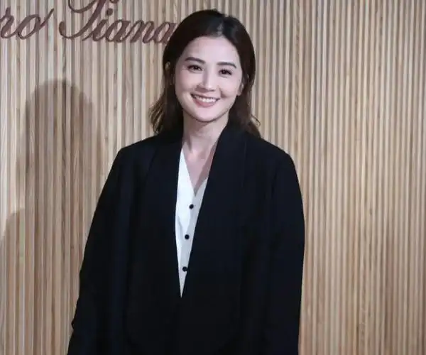 蔡卓妍留着超美的披肩长发,染着红色的嘴唇,手上拎着白色的包包,气质