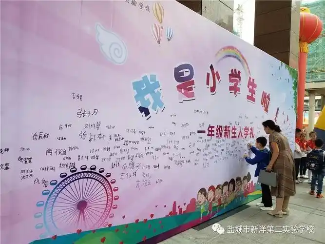 新生们在家长的陪伴下来到签名墙前.