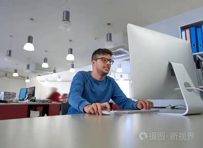 在室内公司办公室工作的设计师年轻人与计算机照片-正版商用图片0500