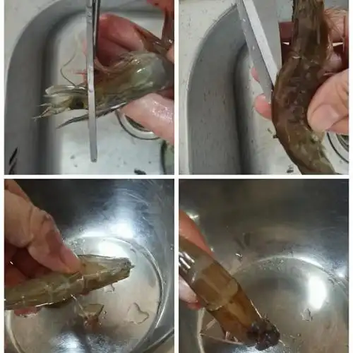 第3步,用剪刀剪去虾头,再剪开虾背,把虾线挑出,虾头里的黑脑挤出来.