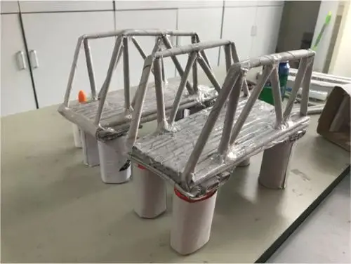 怎样设计纸桥结构能最大化分散桥梁所受的压力?