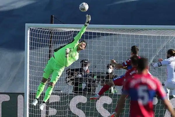 皇家马德里队守门员库尔图瓦(左)在比赛中扑救.