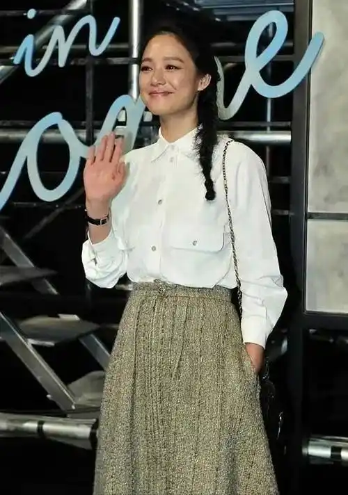 姜文的妻子周韵,人淡如菊,穿白衬衫搭配伞裙,很有文艺范