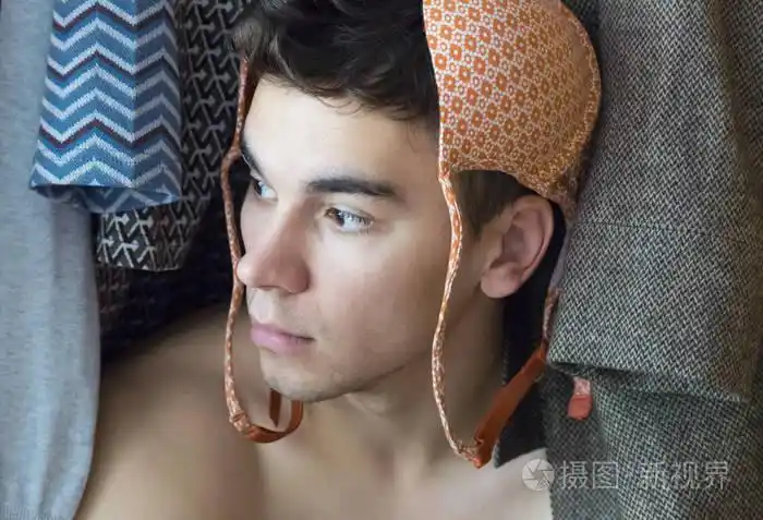 一个戴着胸罩的年轻人藏在壁橱里