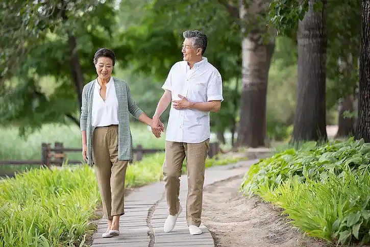 老年夫妇在公园牵手散步