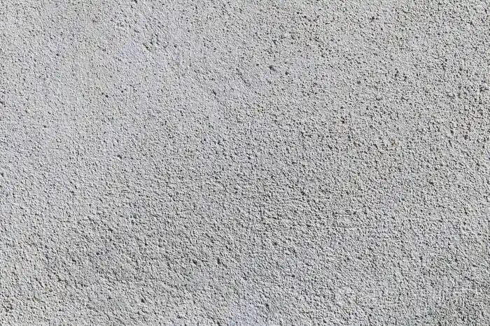 灰色纹理水泥墙背景与细混凝土碎片建设背景