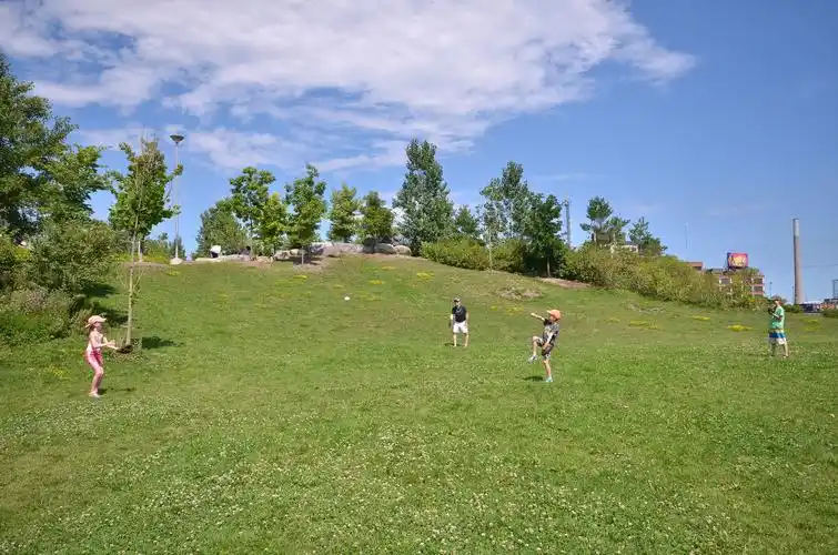 a young family plays catch on the gently sloping hills at cork