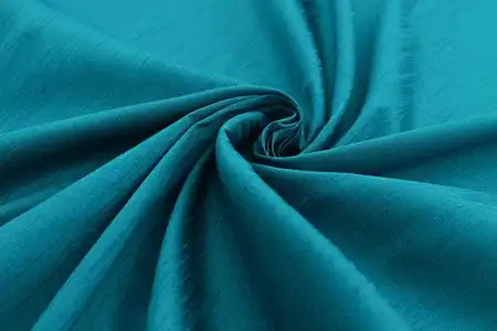 绿丝绸绿松石背景豪华型布或波浪褶皱的 grunge 丝绸质地缎照片