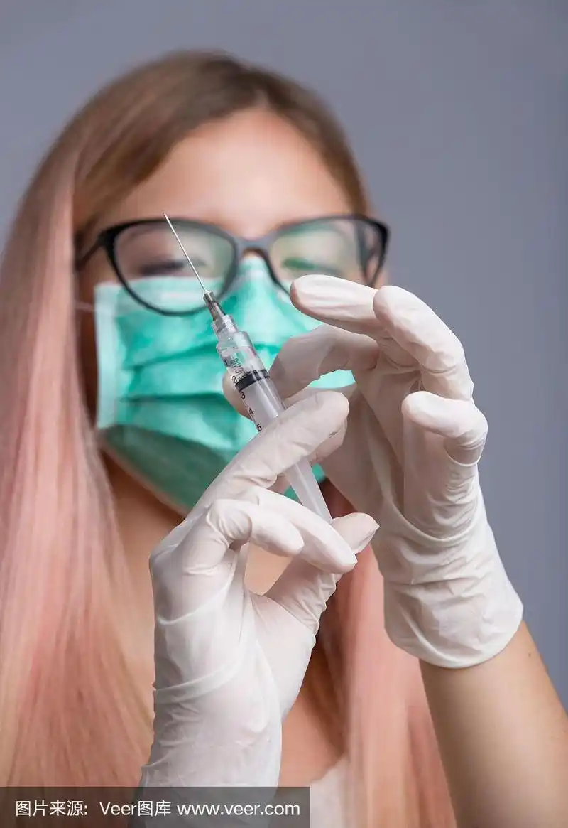 年轻漂亮的护士与注射器针隔离在灰色背景