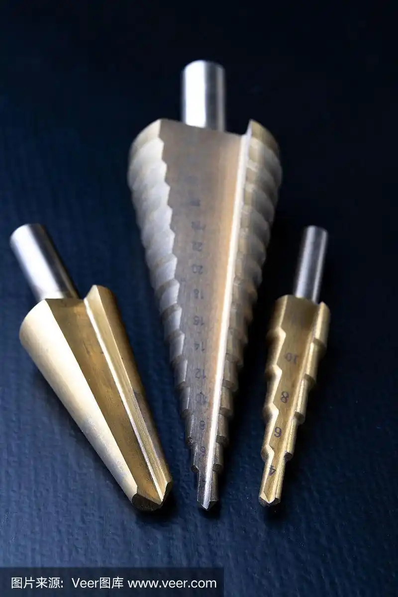 在工作台上的锥形钻头.机械师打孔用的配件.黑暗的背景.