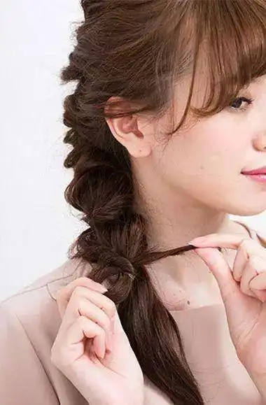 沿着中间的那股头发,将两股头发交叉着扭转起来,一直缠绕到发尾,用小