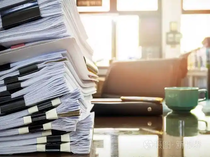 将业务文件堆放在办公桌报告文件堆上
