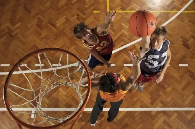 young men playing basketball