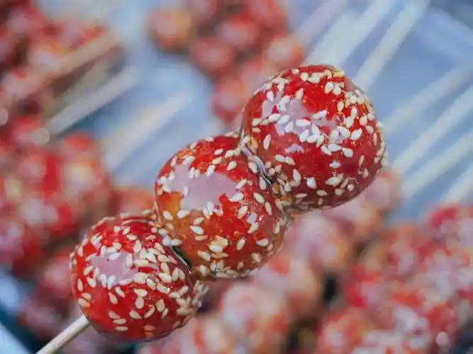 手里拿上一串冰糖葫芦,时不时地咬上一口,入口的酸味儿与甜味儿,让人