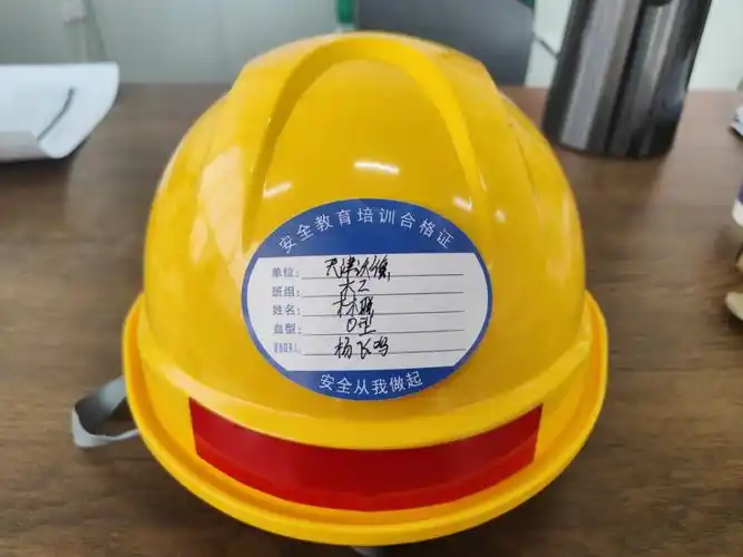 公服公司雄东综合文体中心项目在新员工入职时在其安全帽上张贴帽贴