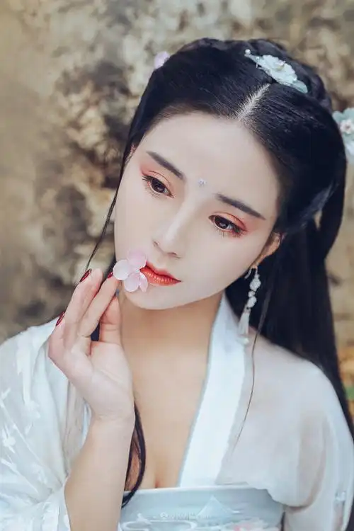 嘴边咬着鲜花的古典真人美女图片