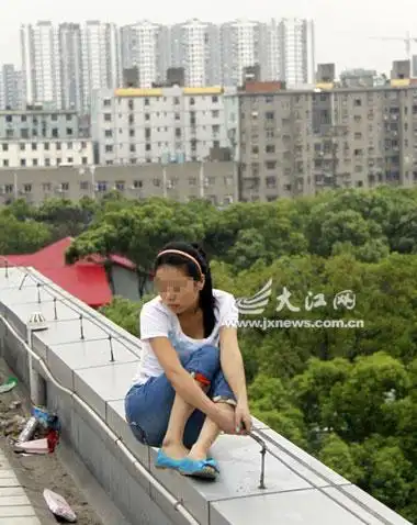 轻生女子坐在天台边很危险.