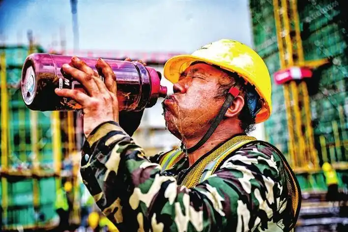 建筑工人在大口大口地喝水.