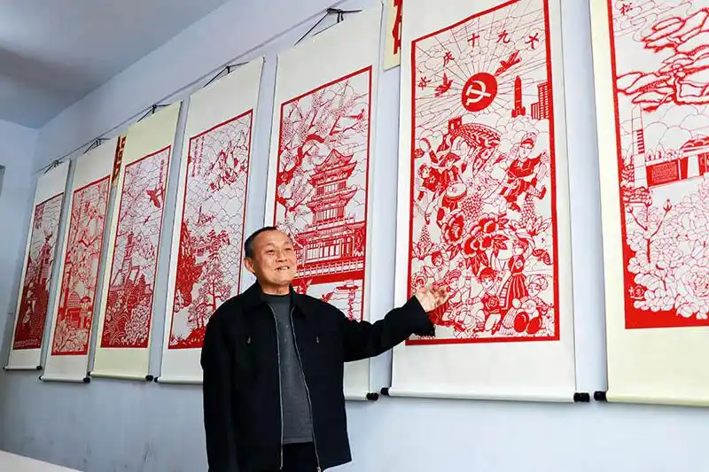 韩运水展示创作的建党100周年主题剪纸.(摄影 石智飞)