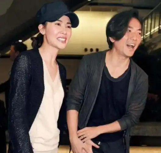 郑伊健蒙嘉慧庆结婚十周年,夫妻手挽手逛街,女方笑靥如花状态好