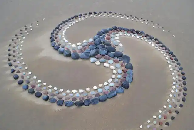 他用石头摆出一堆"小蘑菇",还用小树枝摆出了烟花效果