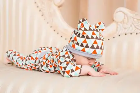 阳光明媚的卧室里可爱的小男孩.新生儿童放松照片