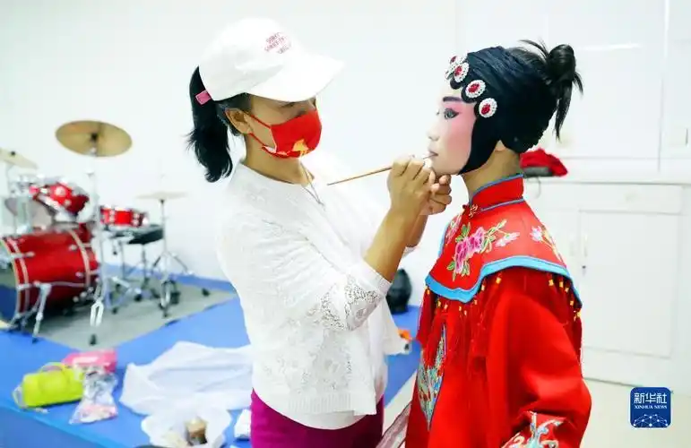 石家庄市井陉县第一小学学生(右)在"第二课堂"学习井陉晋剧表演前化妆