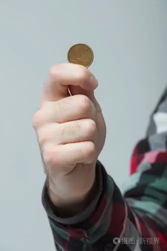 男人的手中拿着一枚硬币显示