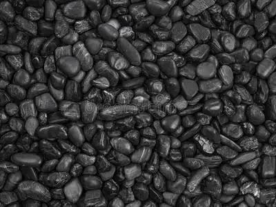 黑色卵石黑色鹅卵石背景照片