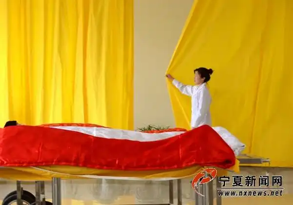 90后整容师徐霏轻轻拉上整容室的窗帘,准备为逝者化妆.