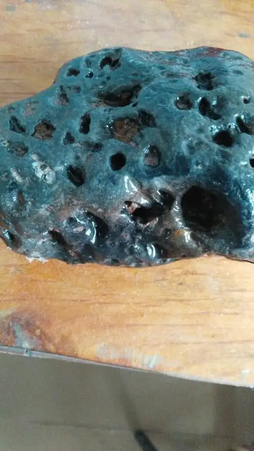 请问我的这块石头是陨石还是火山岩.有融壳气印,有磁性.