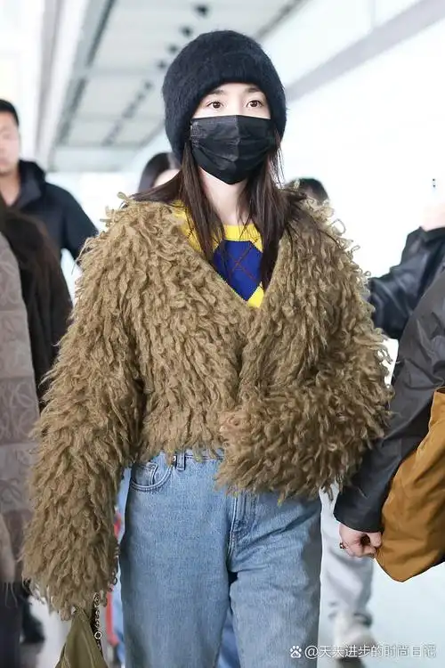 杨幂最新街拍来了,她戴了一顶黑色的针织帽子,穿了一件卡其色的长毛v