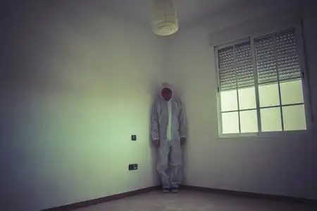 晚上房间行走与红色的面具的男人照片