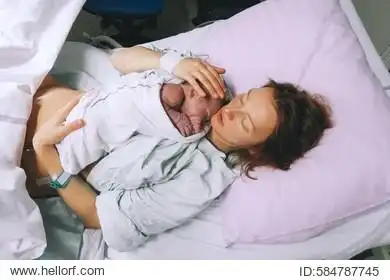 mother giving birth to a baby boy.