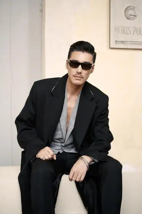 胡兵出席givenchy巴黎男装周大秀黑色长外套搭配灰色格纹西装