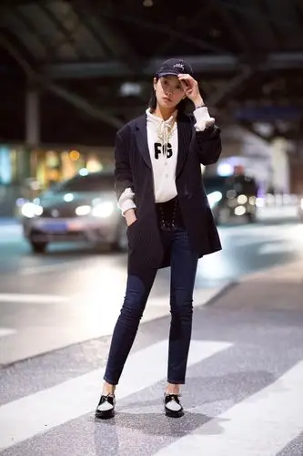 她身着白色字母卫衣外搭廓形休闲西装外套,牛仔裤配漆皮牛津鞋,舒适