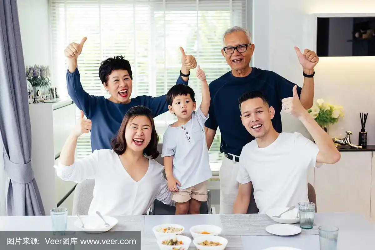 亚洲大家庭三代同堂共进晚餐,在家里高兴地竖起大拇指