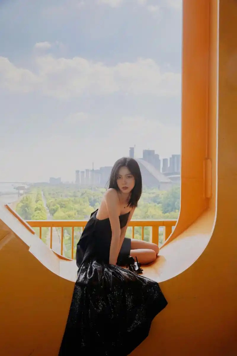 庄达菲穿着黑色一字带高跟鞋,仿佛夜空中的星光,闪烁着迷人的光芒