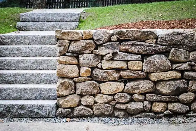 stacked fieldstone retailing wall with granite steps
