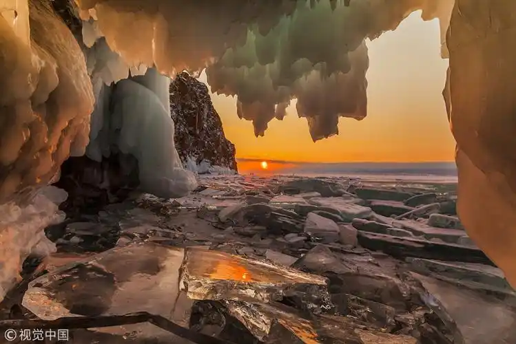 winter sunlight paints ice stalactites gold and blue