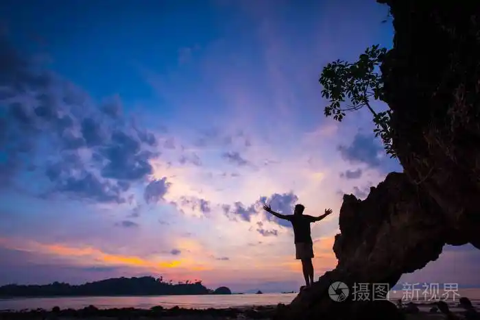 一个人的剪影在自然的日落在夏天用张开的手自由概念
