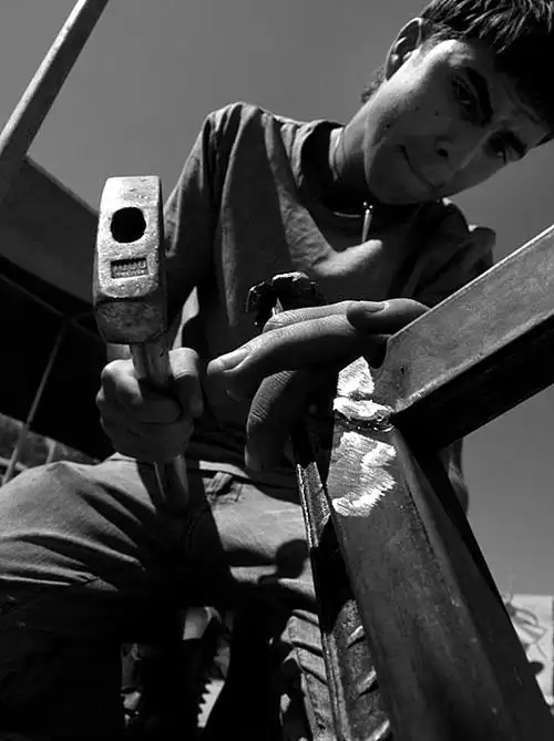 child worker working with hammer