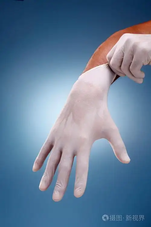 手把上外科手套在创造性的蓝色背景