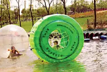 游客在玩水上悠波球