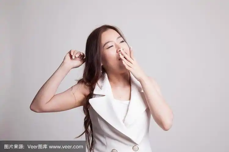 昏昏欲睡的年轻亚洲女人打哈欠.