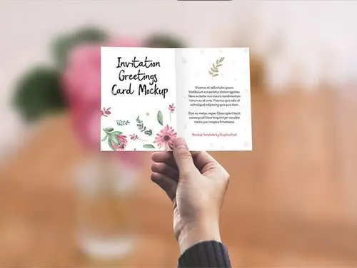 invitation / greeting card in hand mockup psd